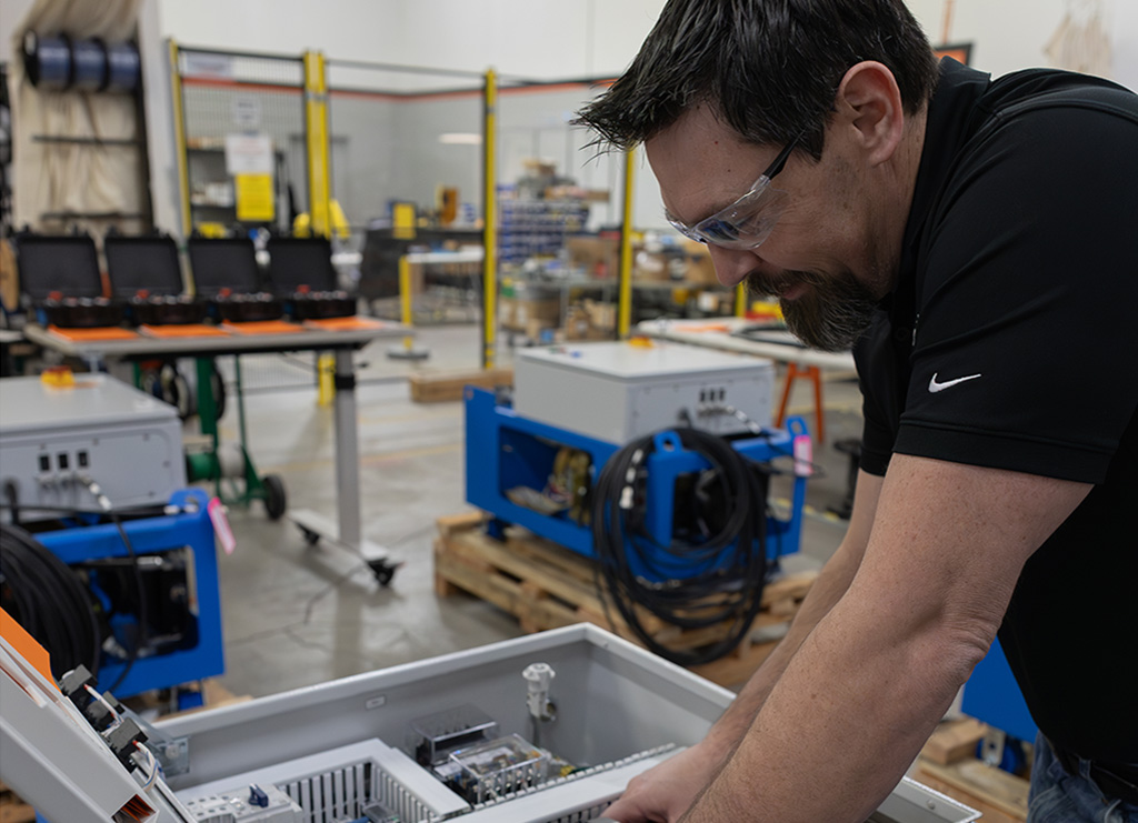 Guy leaning over machine